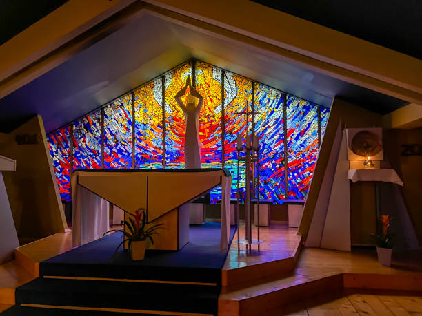 Church Pew Empty with Shimmering Colorful Light From Stained Glass Window - Colorful light patterns on empty pew seat in large cathedral church.