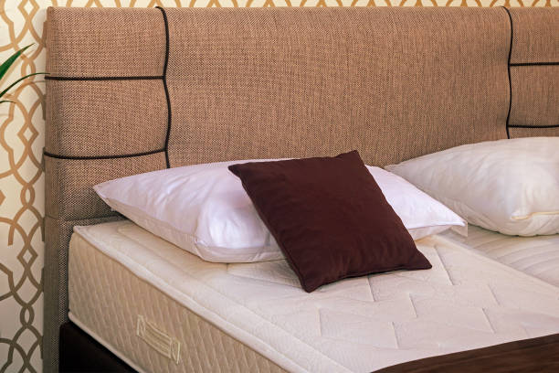 istock Pile of pillows on empty bed 2174518036