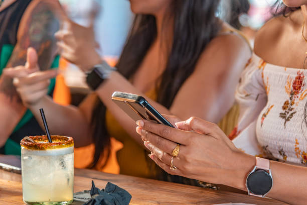 istock Woman Texting at Bar 2174524287
