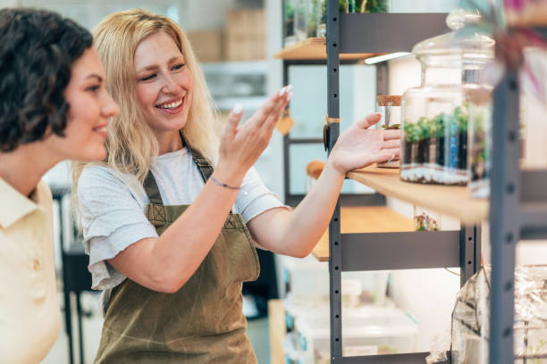 istock Beautiful flower shop owner  with client 2174524743