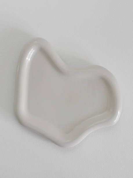 Abstract Cream-Colored Shaped Dish Hanging On Wall