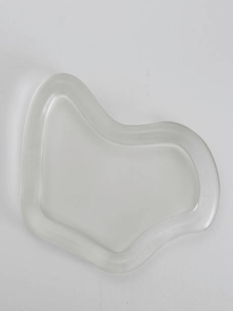 istock Elegant Translucent Dish With Curves Against Wall 2174531143