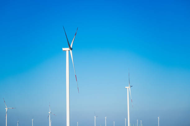 istock Renewable energy wind farm with wind turbines under bright sunny skies 2174531904