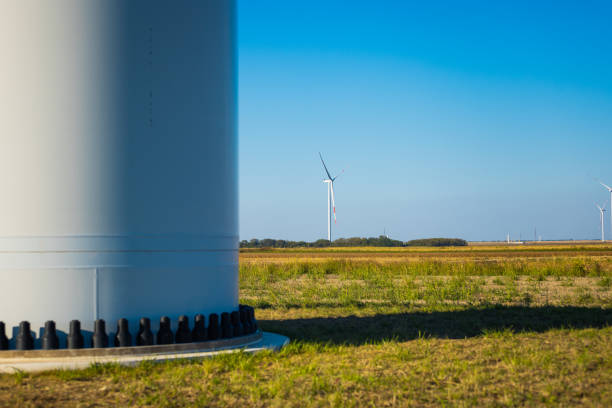 Wind turbines on a renewable energy farm in a rural Serbian landscape, operating under bright sunny skies, highlighting sustainable green energy sources.
