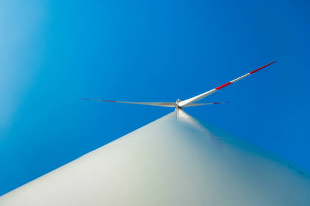 Wind turbines on a renewable energy farm in a rural Serbian landscape, operating under bright sunny skies, highlighting sustainable green energy sources.