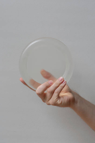 istock Hand Holding A Circular Transparent Disc With Care. 2174535983