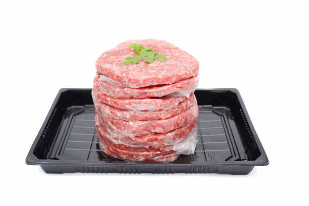 istock Stack of Fresh Raw Beef Burger Patties in Black Tray Isolated on White Background 2174536032
