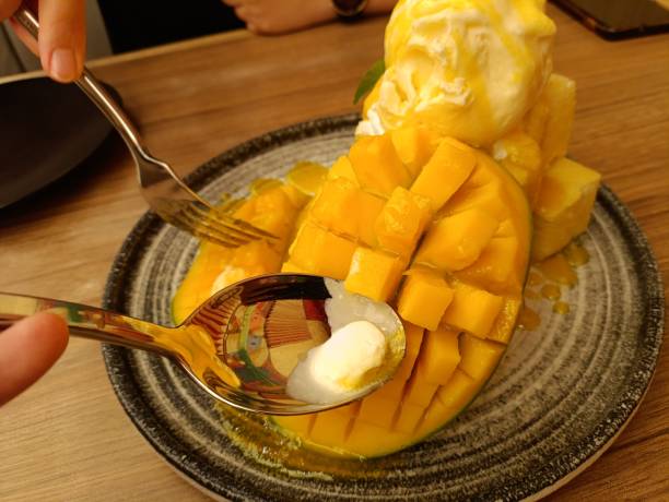 istock Mango, vanilla ice cream and crispy cakes with mango sauce 2174540272