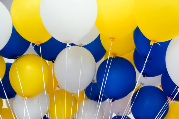 istock a collection of blue, yellow and white balloons 2174540433