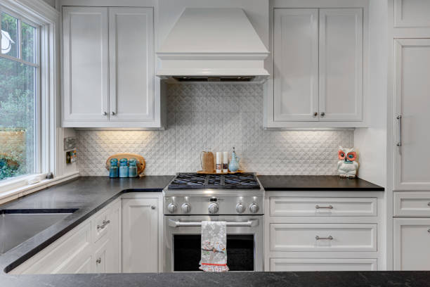 istock Modern Kitchen With Stove, White Cabinets, Black Countertop 2174545101