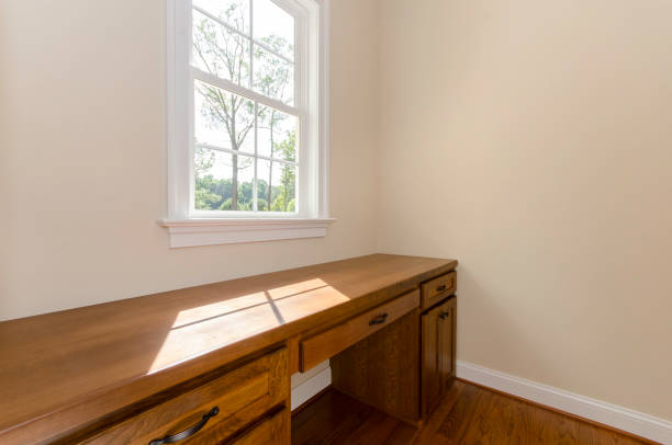 istock Sunlit Wooden Desk Next To Window In Bright Room 2174545313