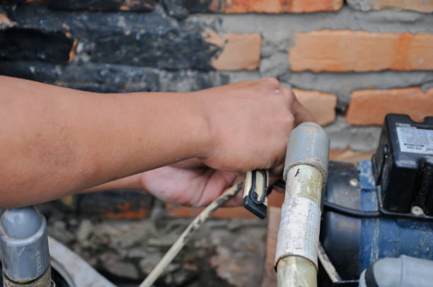 man is repairing a water machine