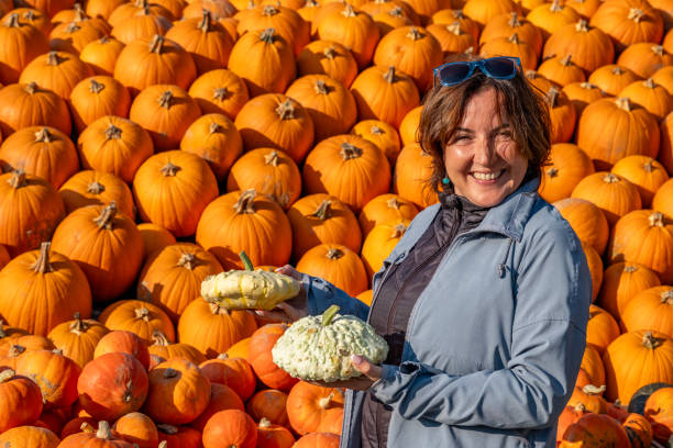 istock Modern farmer showing her pumpkins. 2174546956