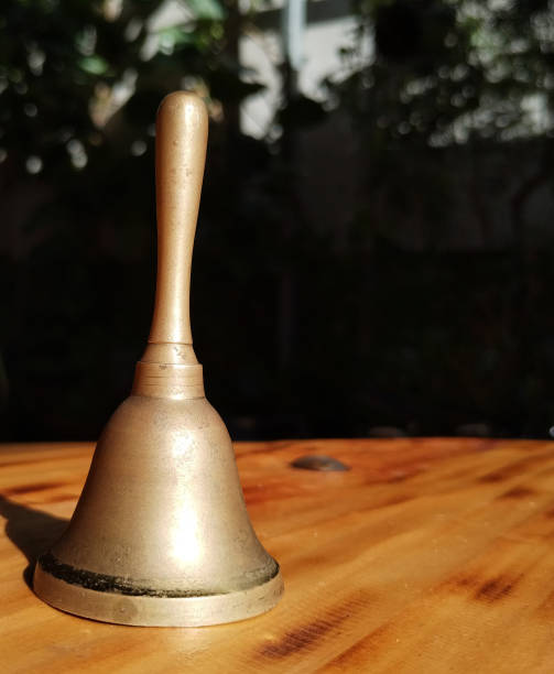 istock Bell is on a table with the sun shining on it 2174549853