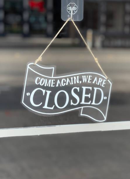 istock Closed sign displayed in a retail stored 2174552758
