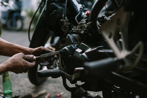 istock A motorcycle mechanic inspecting a damaged engine 2174560017