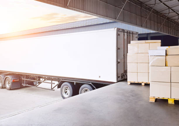 istock Container Trailer Trucks Loads Bulk of Package Boxes at Warehouse Dock. Container Shipping. Distribution Warehouse, Supply Chain, Supplies Shipment Goods. Freight Truck Logistics Cargo Transportation. 2174565466