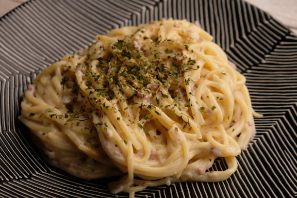 istock Carbonara is a pasta dish made with fatty cured pork, hard cheese, eggs, salt, and black pepper. It is typical of the Lazio region of Italy. 2174566487