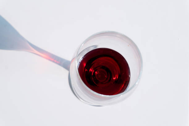 istock wine glass and shadow in sunlight 2174570641