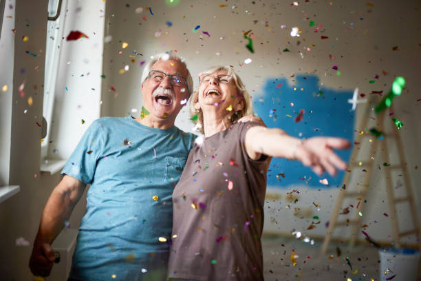 istock Cheerful senior couple among confetti during home renovation process. 2174570846