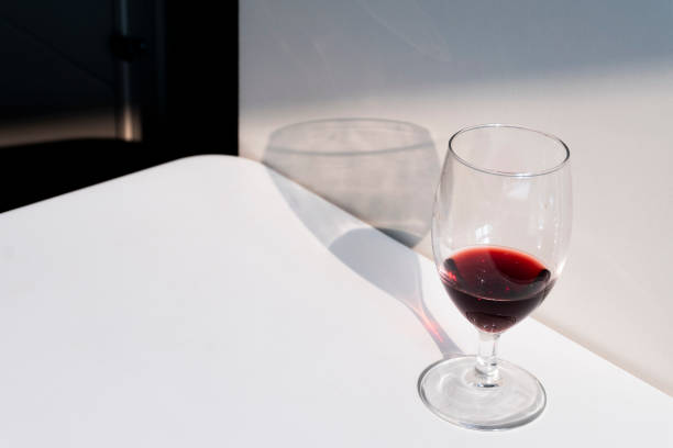 istock wine glass and shadow in sunlight 2174571135