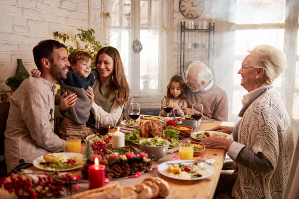 istock Happy extended family talking during lunch in dining room. 2174574010