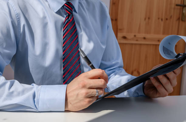 istock Elegantly dressed office worker sitting at desk at work, clerk 2174581308