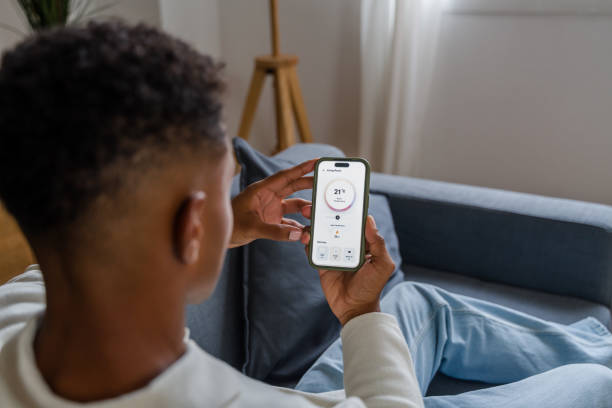 istock Young man controlling home temperature with a smart home app 2174581820