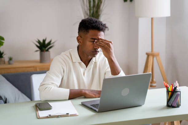 istock Young man feeling tired and frustrated working with laptop computer at home office 2174582988