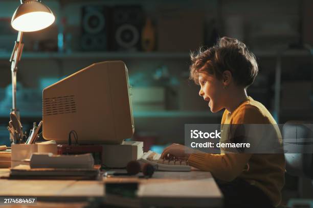 Smart Kid Using An Old Computer At Night Stock Photo - Download Image ...