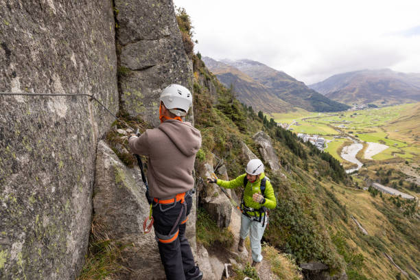 istock Diverse Climbers Fastening Safety Gear on a Steep Mountain Rockface 2174584861
