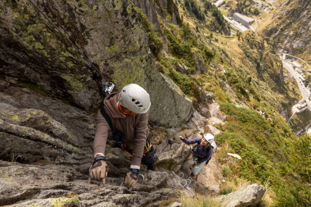 istock Climbers on a Precarious Alpine Trail with a Majestic Valley View 2174584964