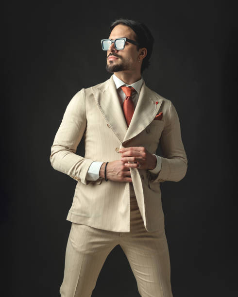 alpha male in beige suit looking up to side