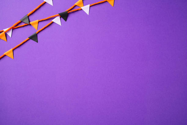 istock Halloween bunting garland on purple background. 2174589337