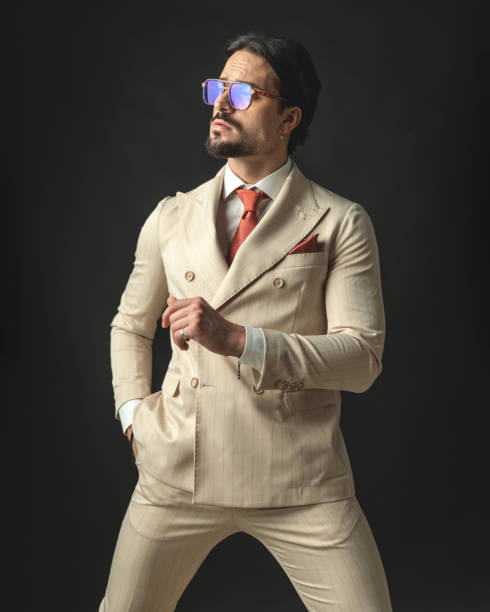 istock male model in beige suit is looking up to side 2174589382