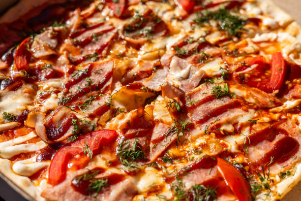 Pizza. Hawaiian Pizza. Pineapple Pizza. Pizza with pineapple, ham, onions cheese tomatoes bacon