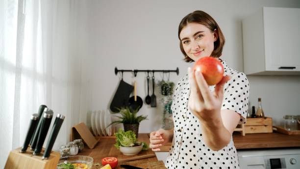 istock Energetic mother select fruit and looking at camera while hold apple. Pedagogy. 2174589808
