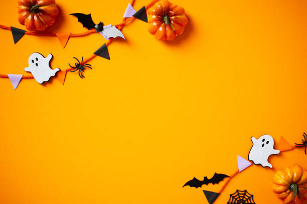 istock Happy Halloween concept. Flat lay composition with bunting, pumpkins, ghosts, bats on orange background. 2174590476