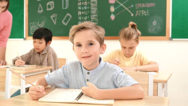 istock Happy caucasian boy looking at camera while studying math at school. Pedagogy. 2174591065