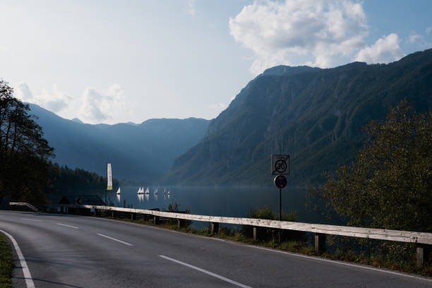 istock alpine lake with mountain and road 2174594176