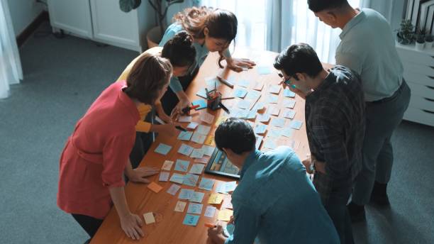 istock Top view of manager writing idea on sticky notes and explain idea. Symposium. 2174597677
