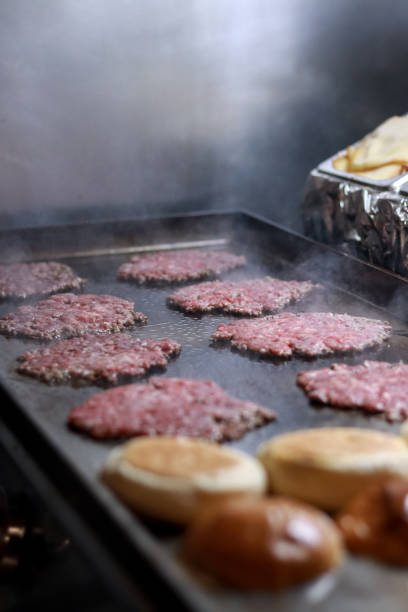 istock Raw smash burger sizzling on a hot griddle 2174598318