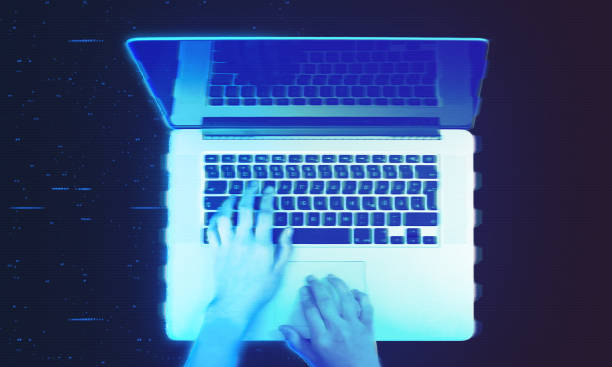 istock Hands typing on laptop hologram projection, augmented reality with glowing blue glitch effects 2174598484