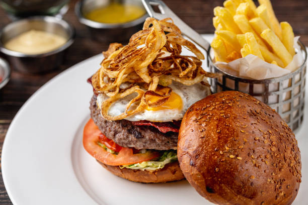 istock Burger with burger patty and egg on wooden table 2174599286