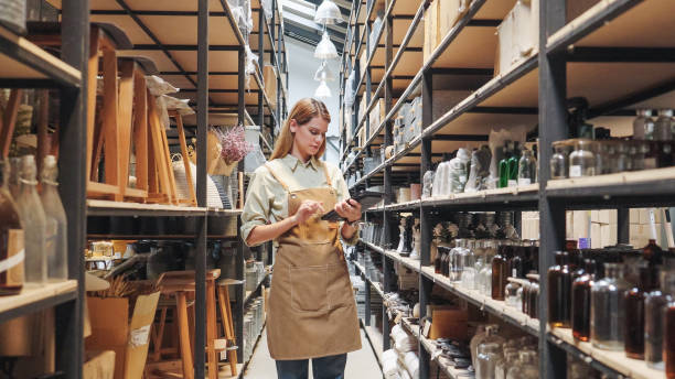 istock A small business warehouse  worker owner wearing aprons counting  checking stock  management on shelves discussing inventory in a well-organized storage compartment checklist 2174600729