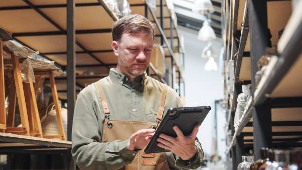 istock A small business warehouse  worker owner wearing aprons counting  checking stock  management on shelves discussing inventory in a well-organized storage compartment checklist 2174600732