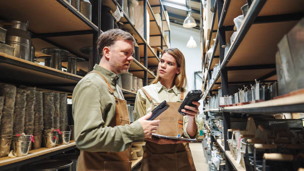 istock A small business warehouse  worker owner wearing aprons counting  checking stock  management on shelves discussing inventory in a well-organized storage compartment checklist 2174600761