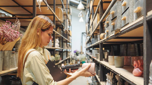 istock A small business warehouse  worker owner wearing aprons counting  checking stock  management on shelves discussing inventory in a well-organized storage compartment checklist 2174600830