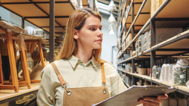 istock A small business warehouse  worker owner wearing aprons counting  checking stock  management on shelves discussing inventory in a well-organized storage compartment checklist 2174600842