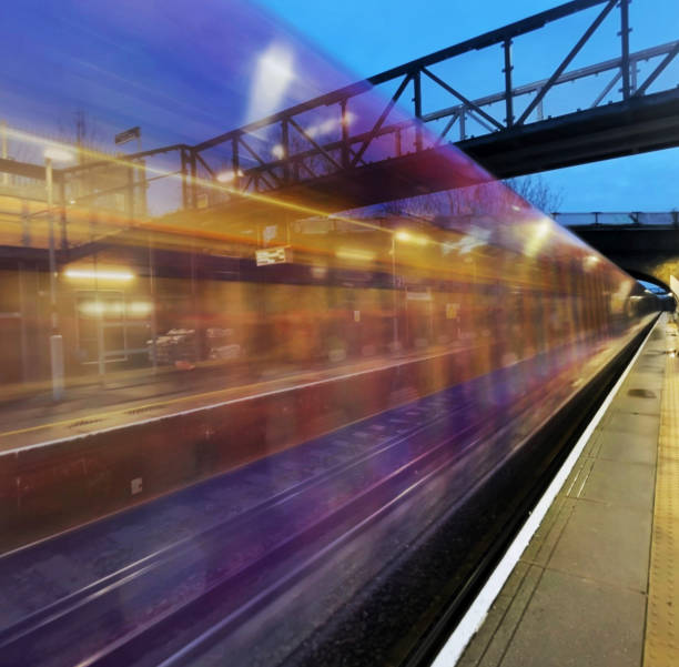 istock Commuter train moving at speed past a platform in London in the evening 2174601531